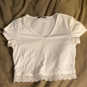 A white and pink crop top with lace